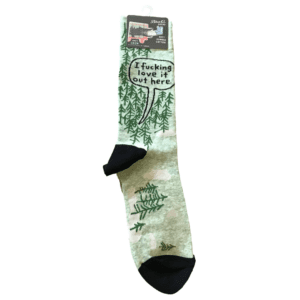 green socks with images of darker green trees, speech bubble "i fucking love it out here"