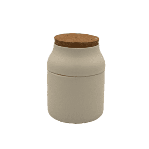 white ceramic grinder and storage jar with cork