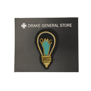 lightbulb shaped embroidered pin "omg"