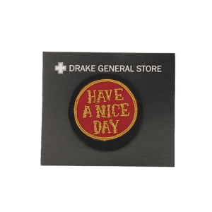 round red pin with gold embroidery "have a nice day"