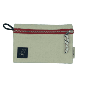 white pouch with red zipper, patch with hand making a peace sign