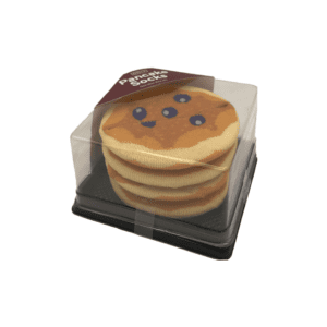 A pair of socks folded to look like a stack of pancakes in a plastic box.