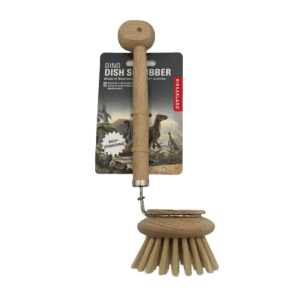 A wooden dish brush shaped like a dinosaur with a cardboard backing